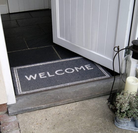 Grey-welcome-mat-with-written-welcome-sign-on-it